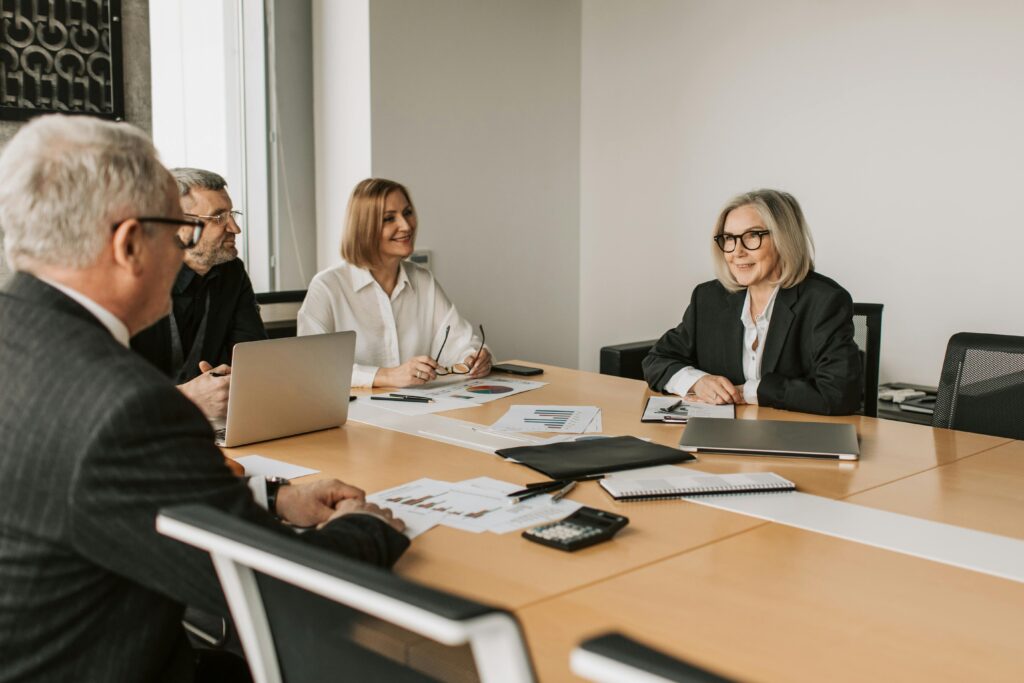 An image of a group of professionals having a meeting in a conference room. 